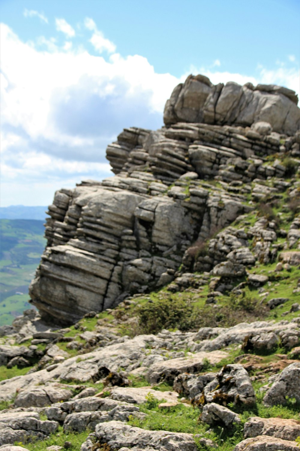 brown rock formation near body of water during daytime