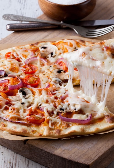 pizza on brown wooden tray