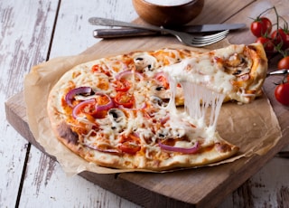 pizza on brown wooden tray