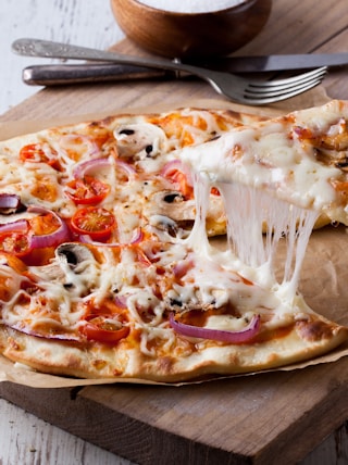 pizza on brown wooden tray