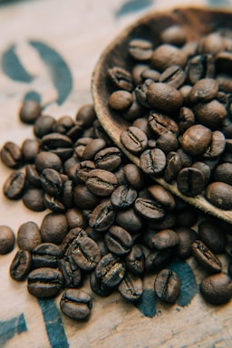 macro photography,how to photograph roasted to perfection, beans from the good cup coffee company; coffee beans on brown wooden bowl