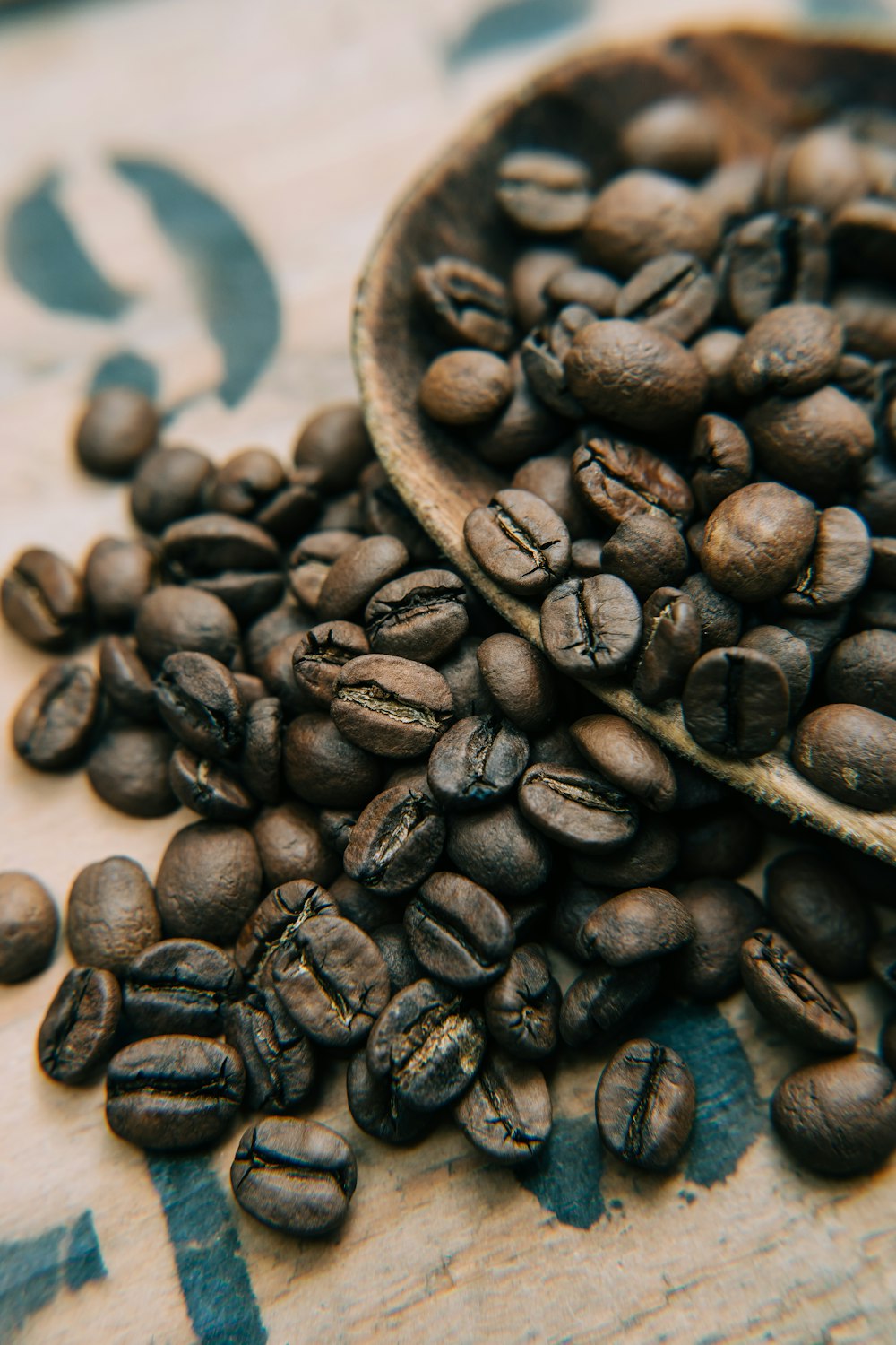 coffee beans on brown wooden bowl