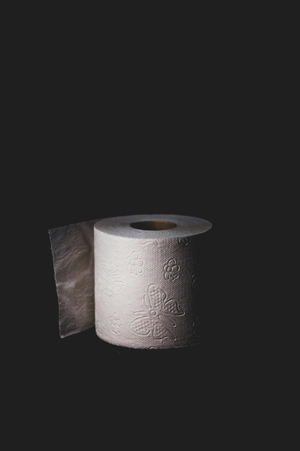 white tissue roll on black surface