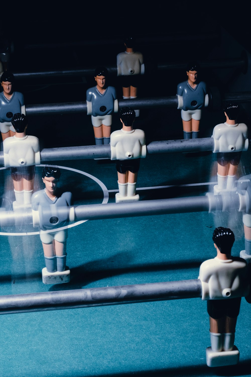 a group of toy figurines standing on top of a soccer field