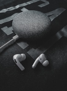 white earbuds on black textile