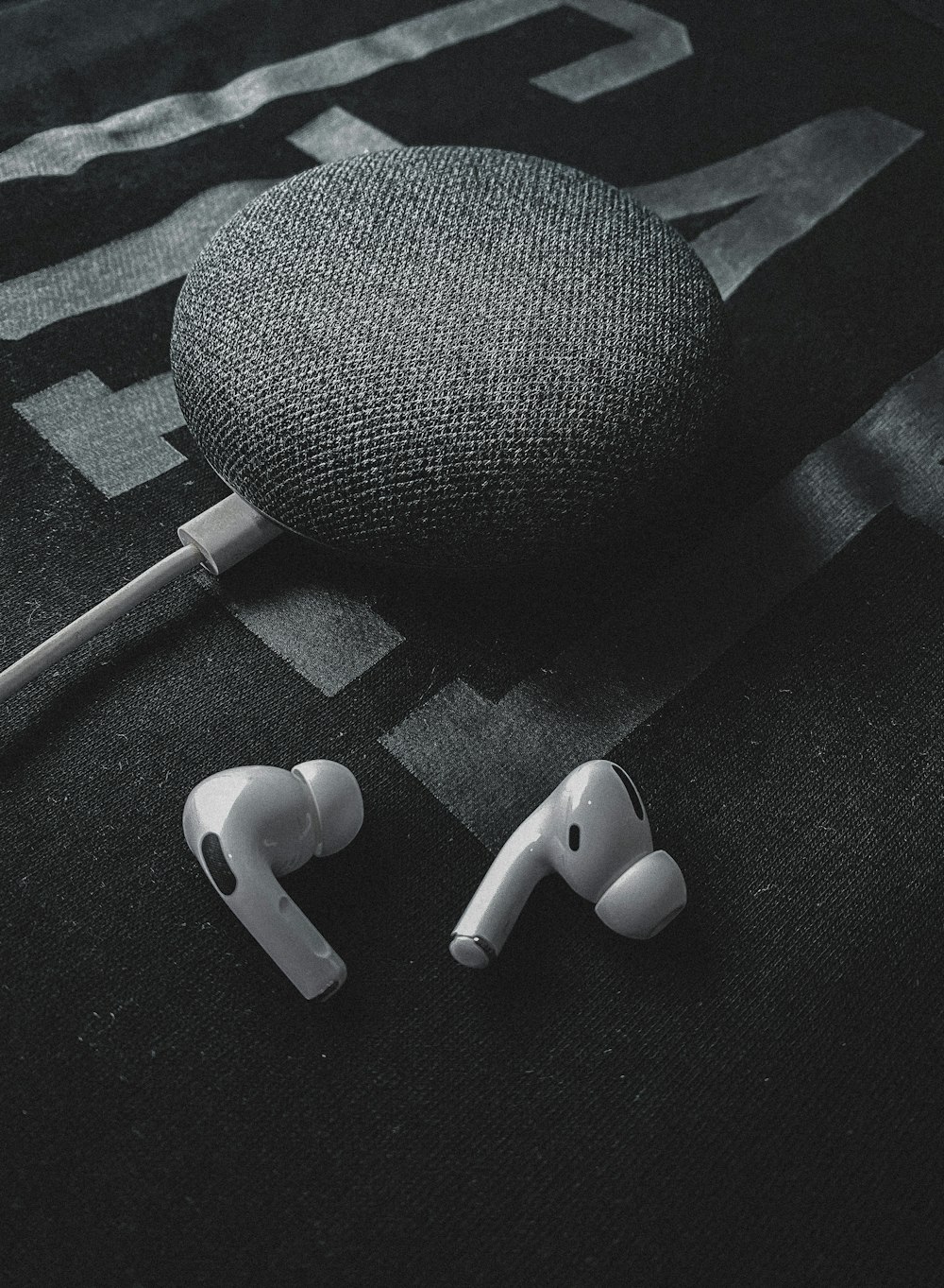 white earbuds on black textile