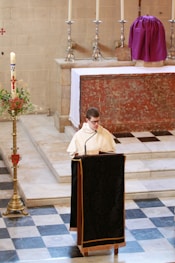 man in white dress shirt sitting on chair