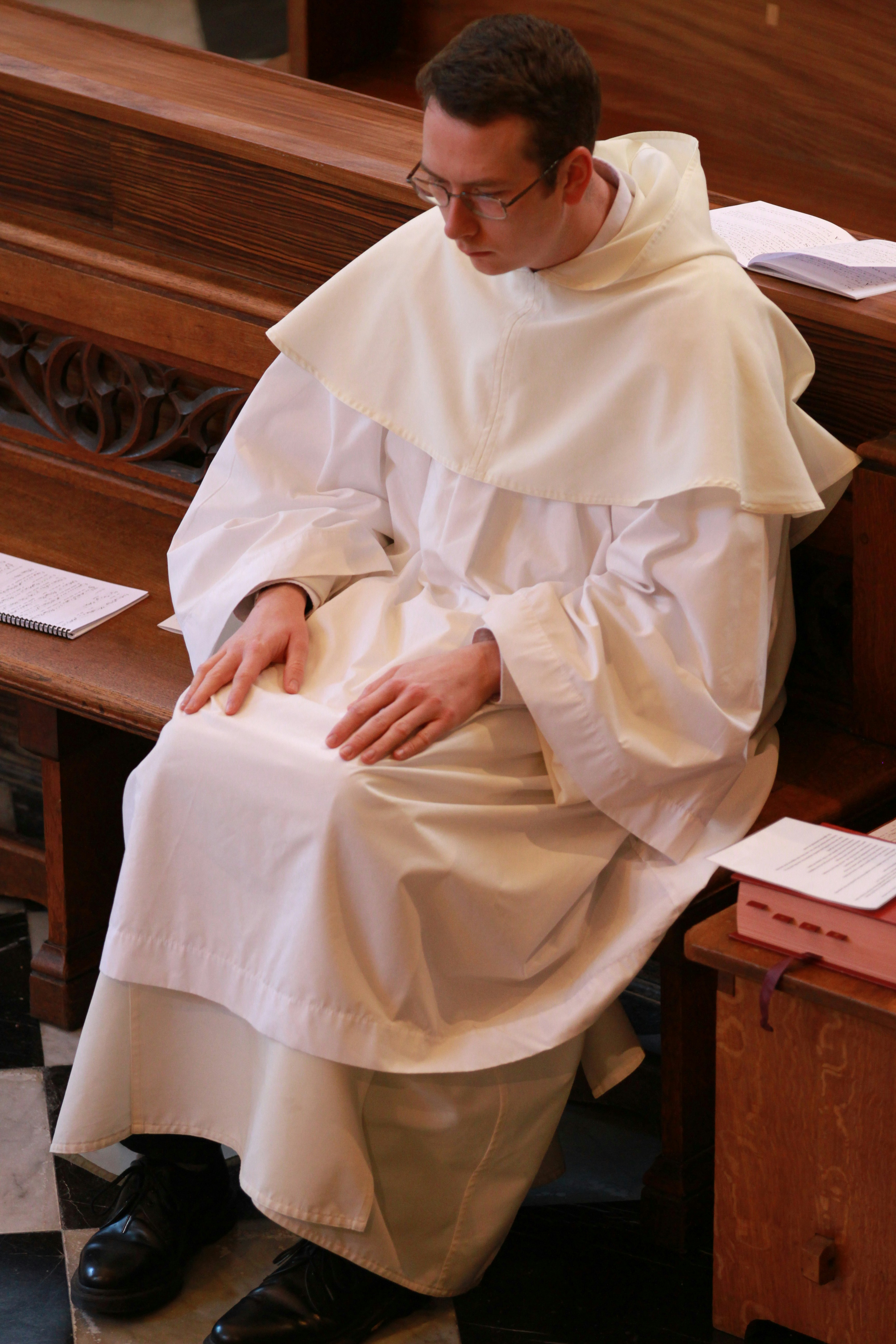 woman in white hijab sitting on brown wooden chair