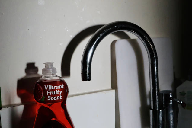 A bright, inviting kitchen countertop with Violetis cleaning products neatly arranged beside a sparkling sink.