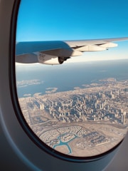 A vibrant city skyline viewed from a plane window, capturing the excitement of urban exploration.
