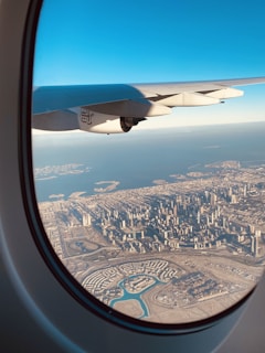 A vibrant city skyline viewed from a plane window, capturing the excitement of urban exploration.