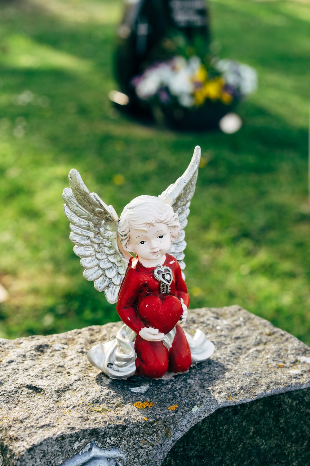 angel ceramic figurine on gray concrete surface