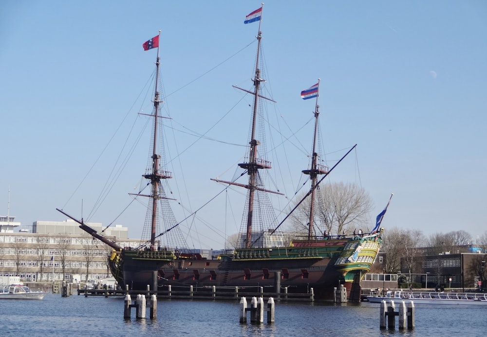 brown and black ship with flags