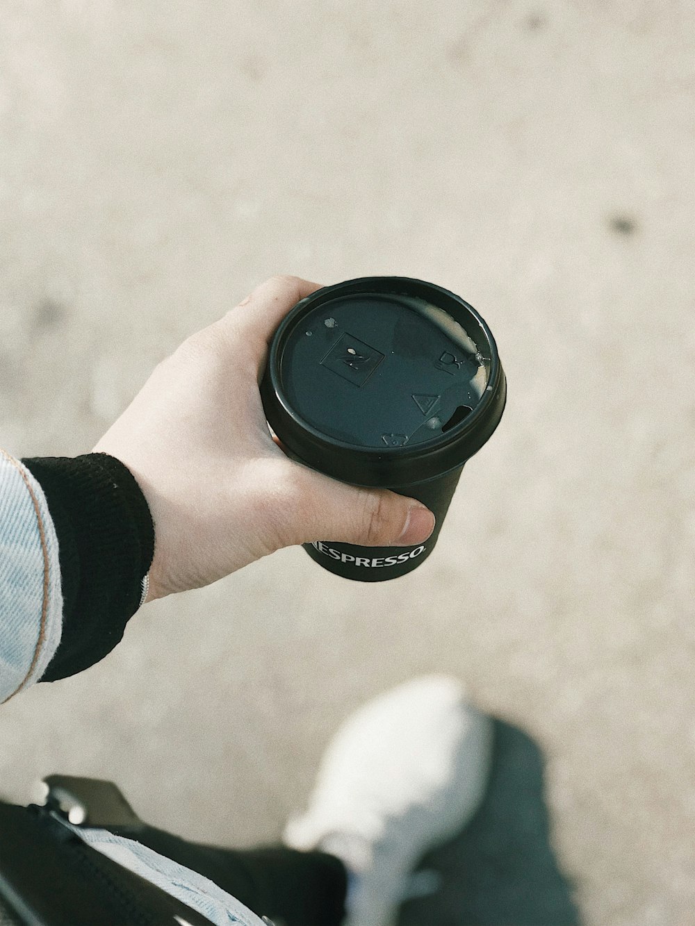 person holding black round container
