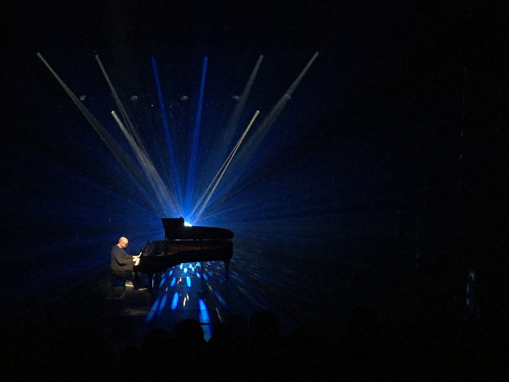 man in black shirt standing on stage