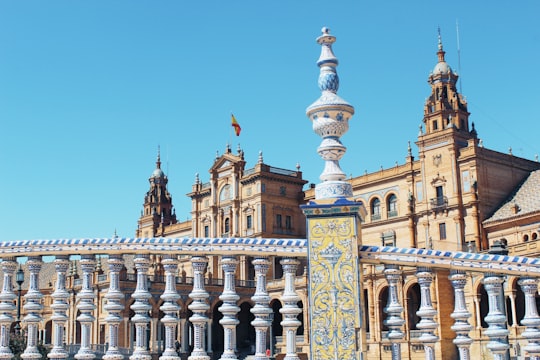 brown and white concrete building under blue sky during daytime in Plaza de España Spain