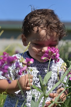Kids smelling fresh herbs and flowers during a sensory activity.