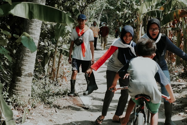 Family laughing together while exploring a lush Caribbean jungle trail.