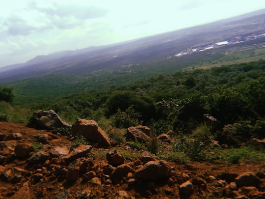 green trees on brown mountain under white clouds during daytime in Ngong Kenya