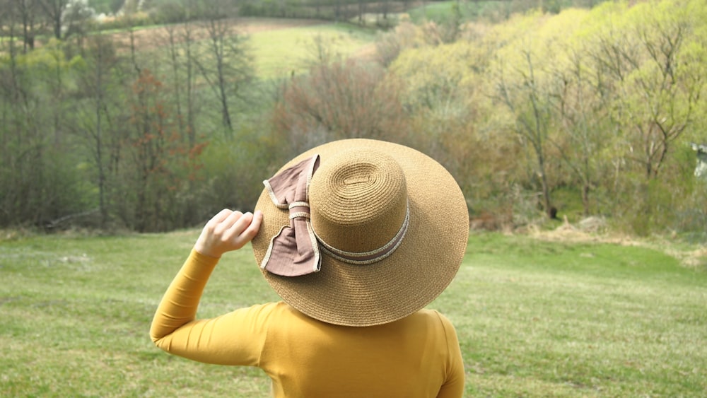 woman in yellow shirt wearing brown sun hat