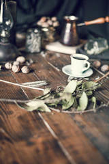 A rustic wooden table with bags of organic coffee beans and vintage brewing equipment bathed in warm sunlight