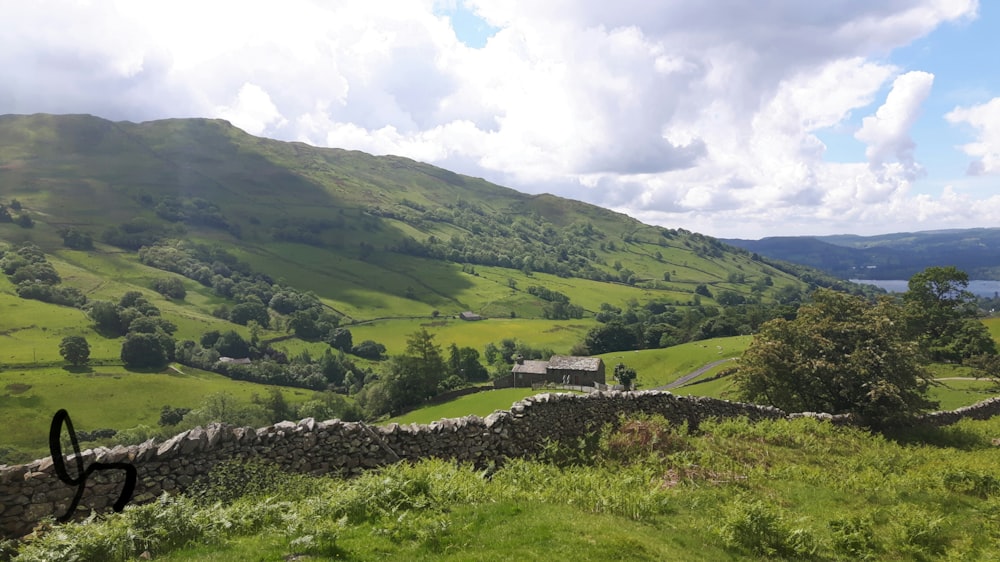 green grass field and mountains during daytime