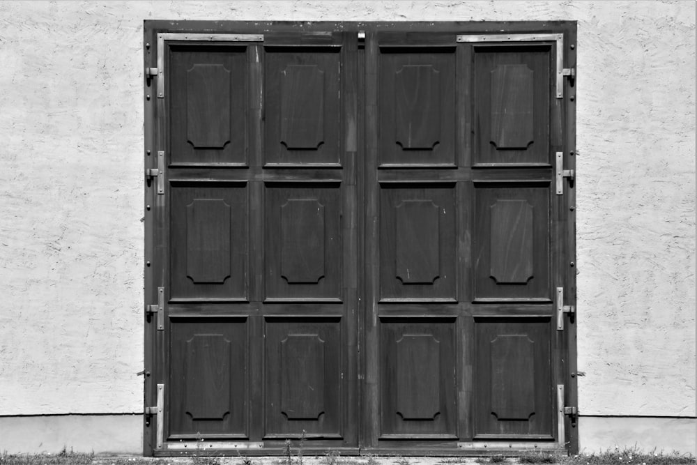 black wooden door in white painted wall