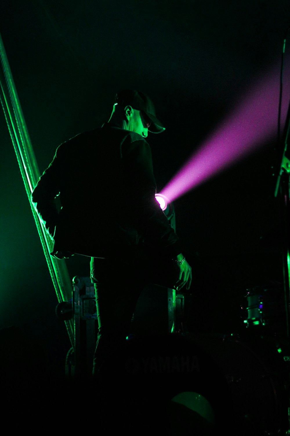 man in black jacket standing on stage