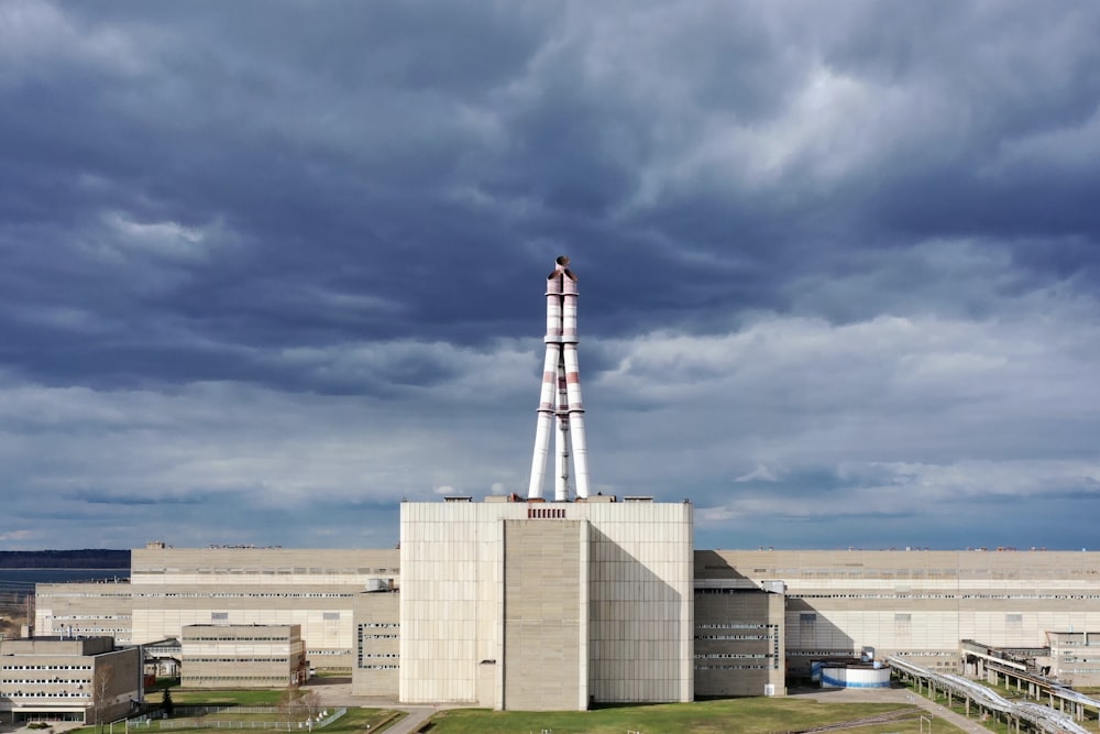 white and red tower under cloudy sky during daytime