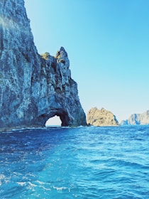 brown rock formation on blue sea under blue sky during daytime