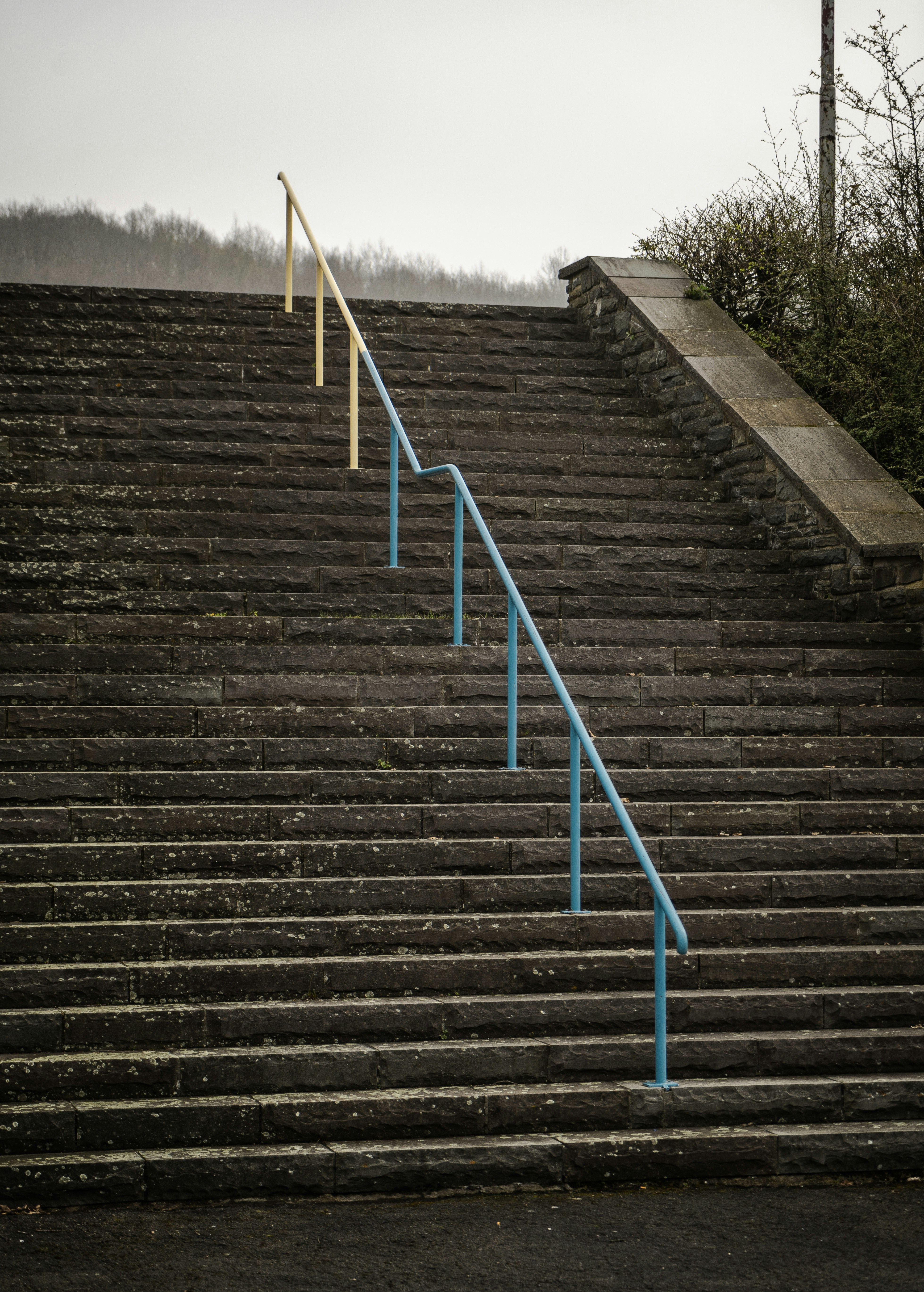 a set of stairs with a blue hand rail