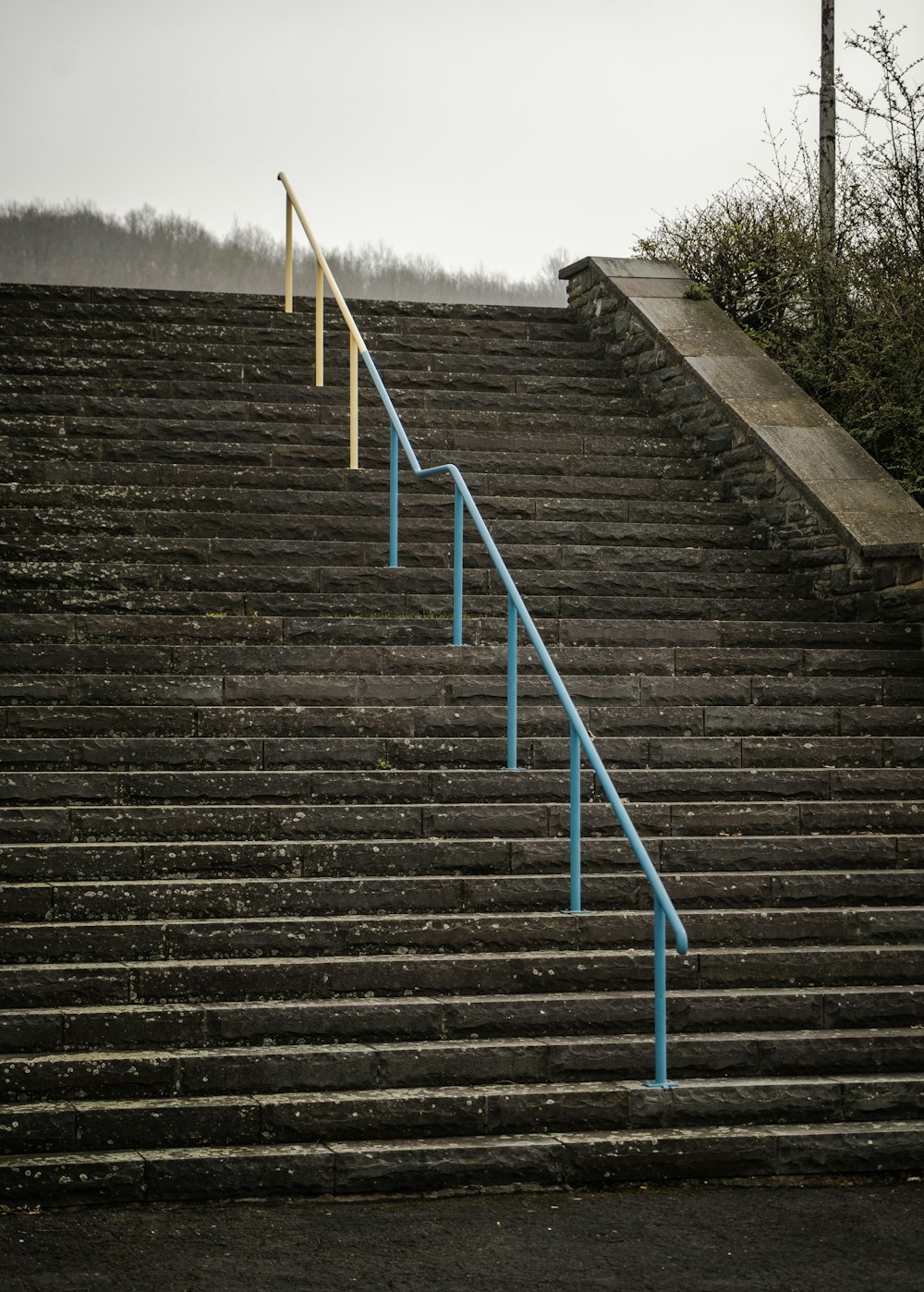 a set of stairs with a blue hand rail