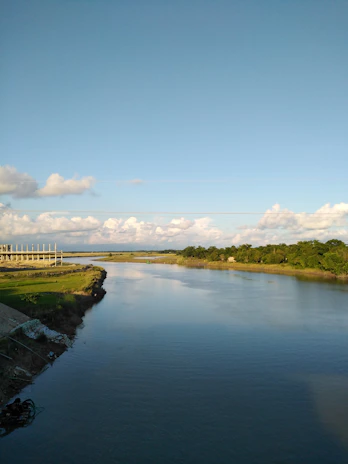 The peaceful river Velika flowing gently alongside the project grounds under a clear blue sky.