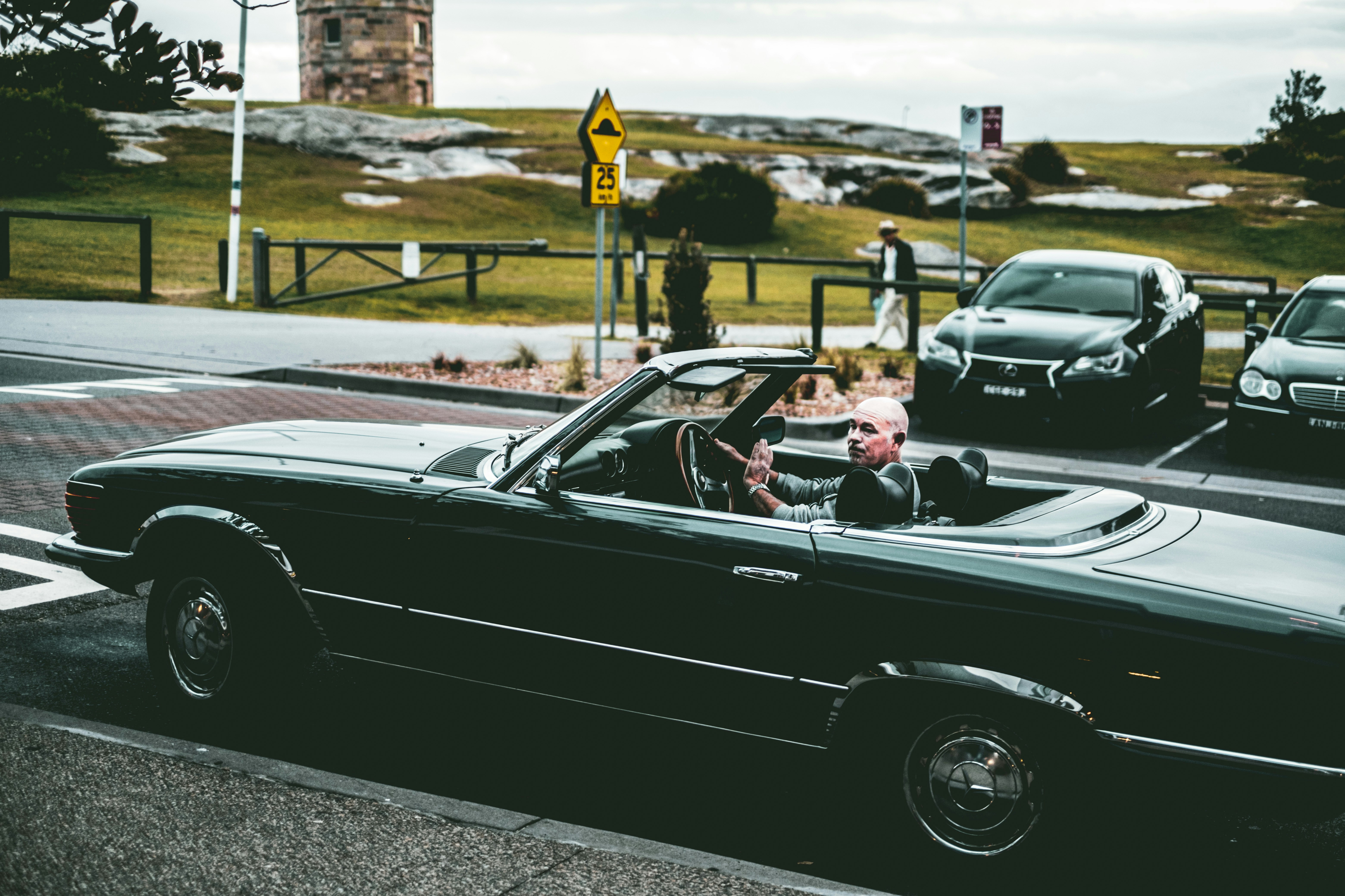 man in black convertible car