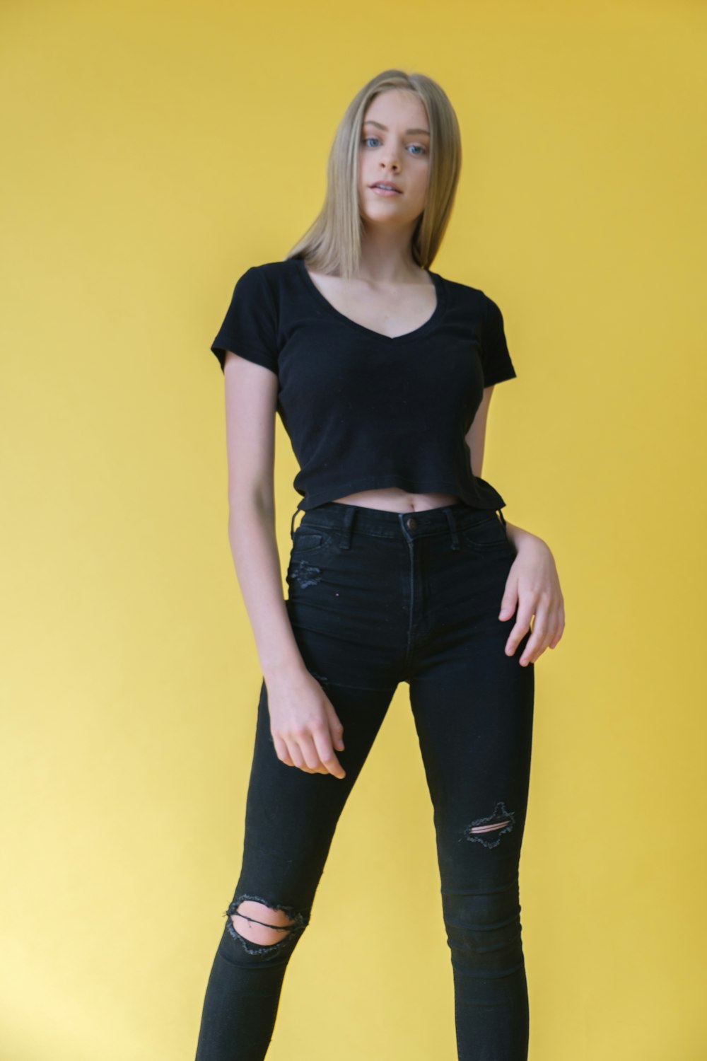 woman in black crew neck t-shirt and blue denim jeans
