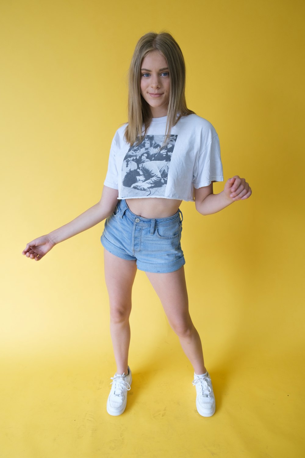 woman in white shirt and blue denim shorts