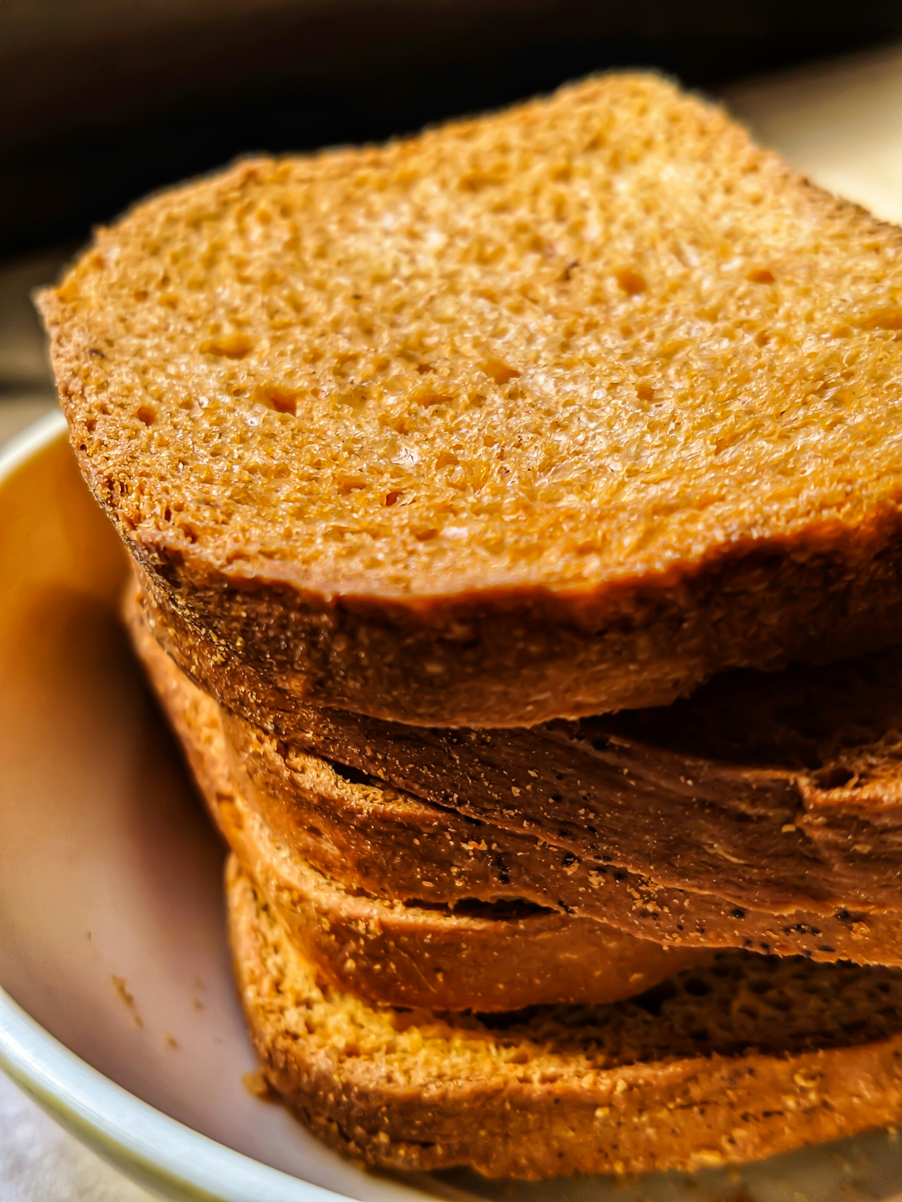 Toasted garlic bread slices with golden butter and marinara sauce in a small bowl