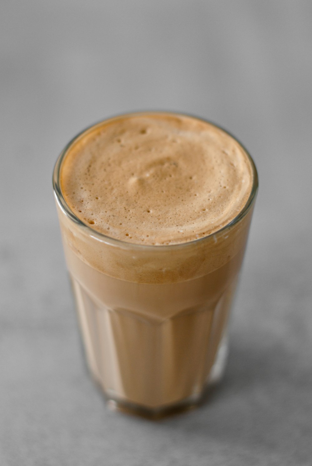 clear drinking glass with brown liquid