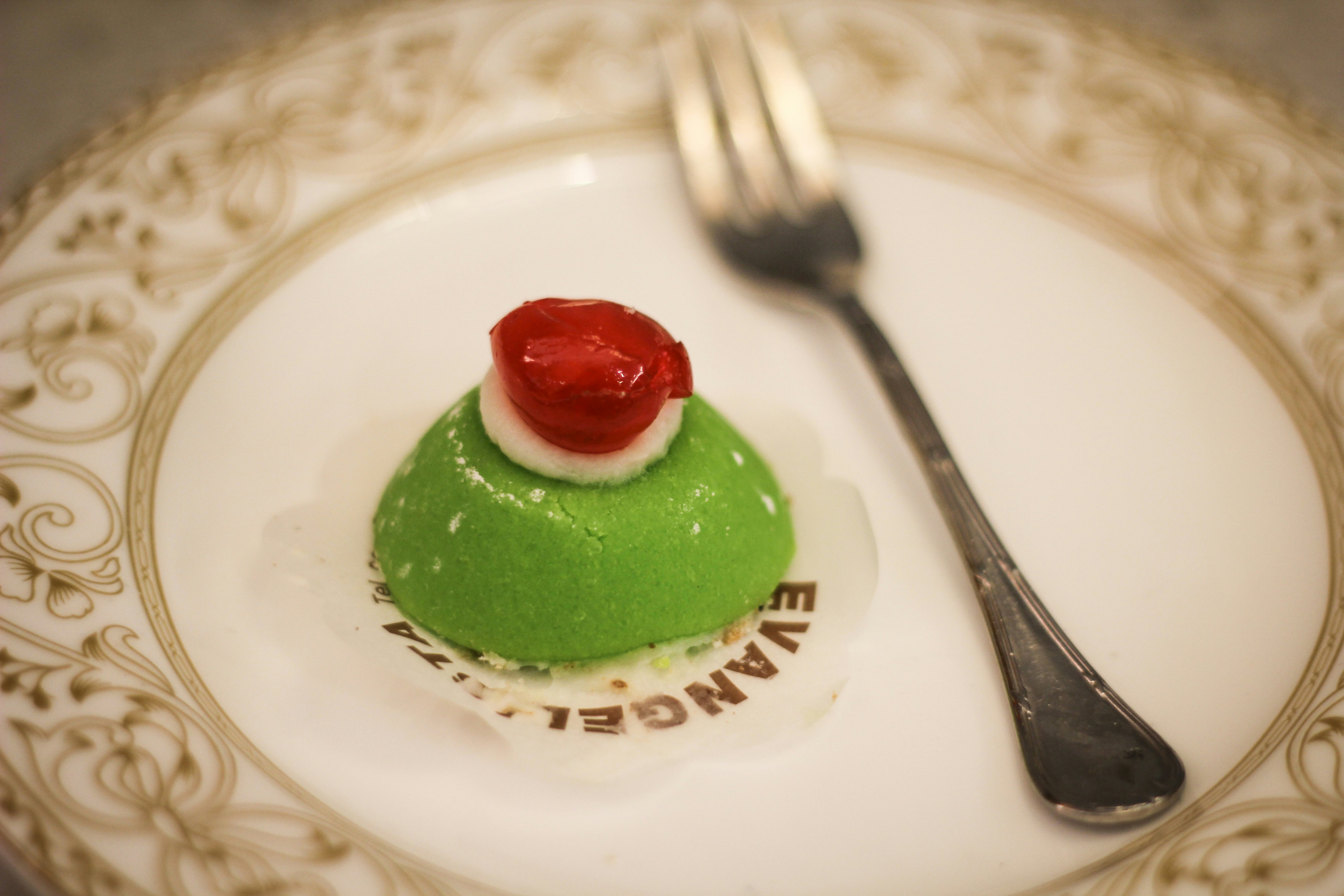 green and white cake on white ceramic plate, Cassata siciliana on a plate with fork. A typical dessert from Sicilia south italy