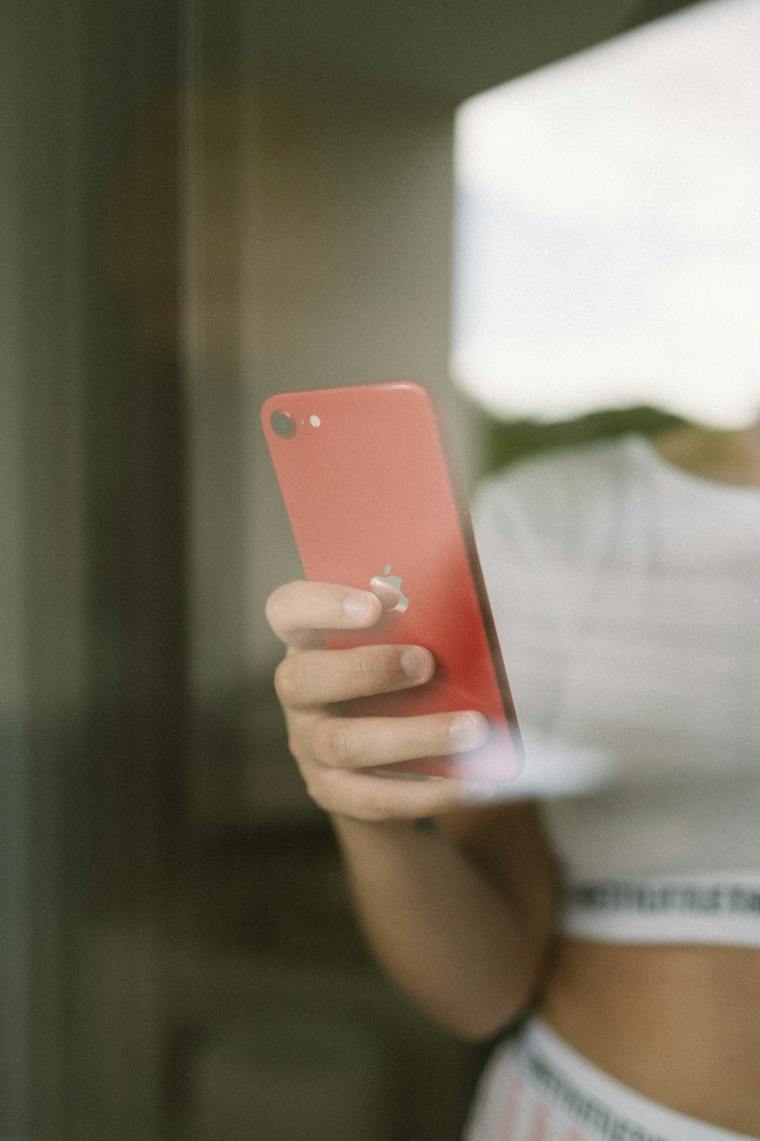 person holding orange iphone case