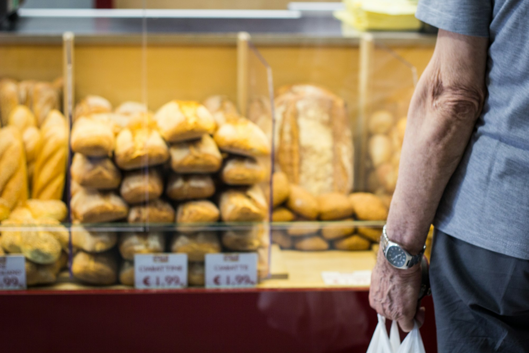 bread counter, old man with a watch hanging a bag