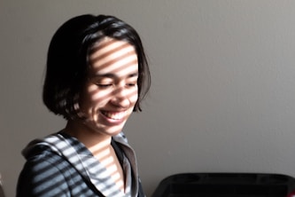 smiling boy in blue white and black plaid collared shirt