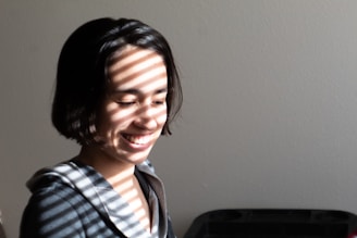 smiling boy in blue white and black plaid collared shirt