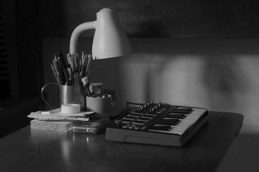 black and white computer keyboard beside white ceramic mug