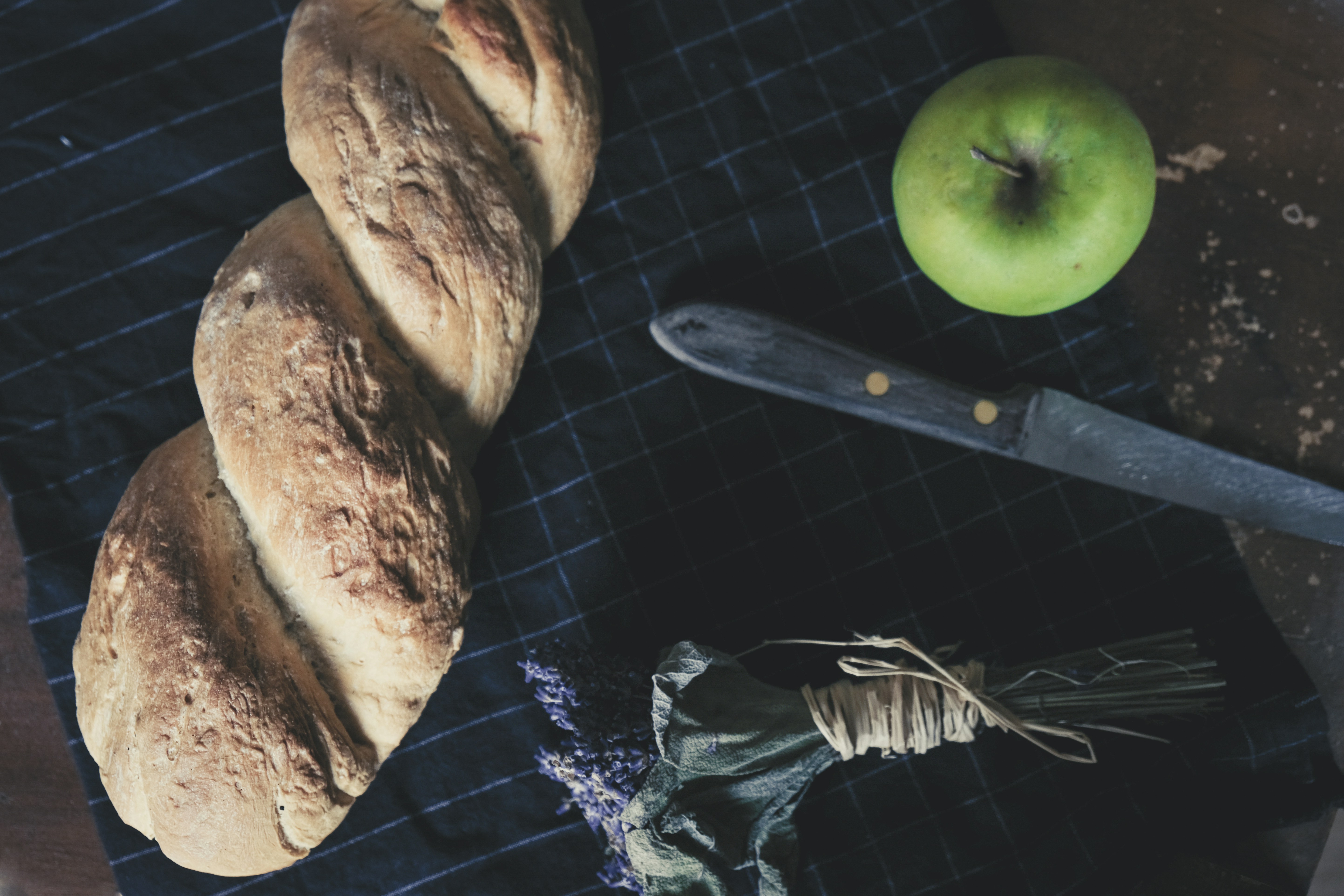 green apple beside bread and bread