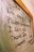 The image displays a message written on a glass or whiteboard with a wooden frame. The message reads 'Dear me, I'm sorry, Please forgive me, I love you, Thank you' with further instructions to repeat it. There is also a small decorative symbol on the right side.