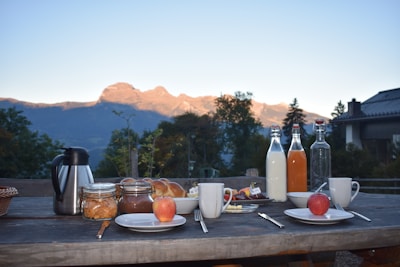 Freshly prepared breakfast baskets arranged on a rustic wooden table outdoors.