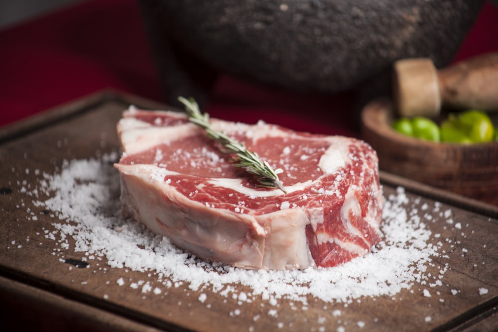 raw meat on brown wooden chopping board