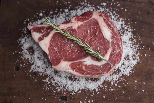 raw meat on brown wooden table