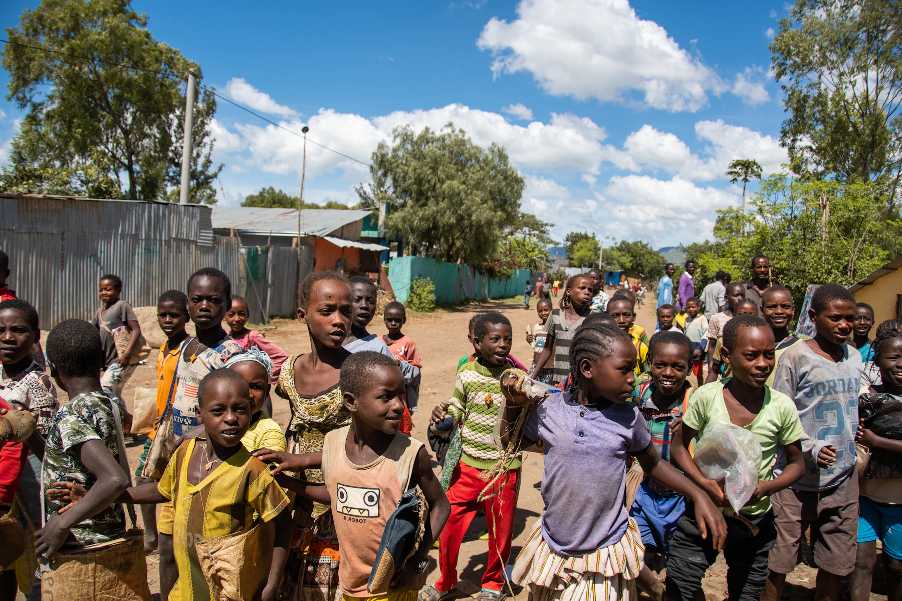 Children running through an outdoor community space at the end of the day